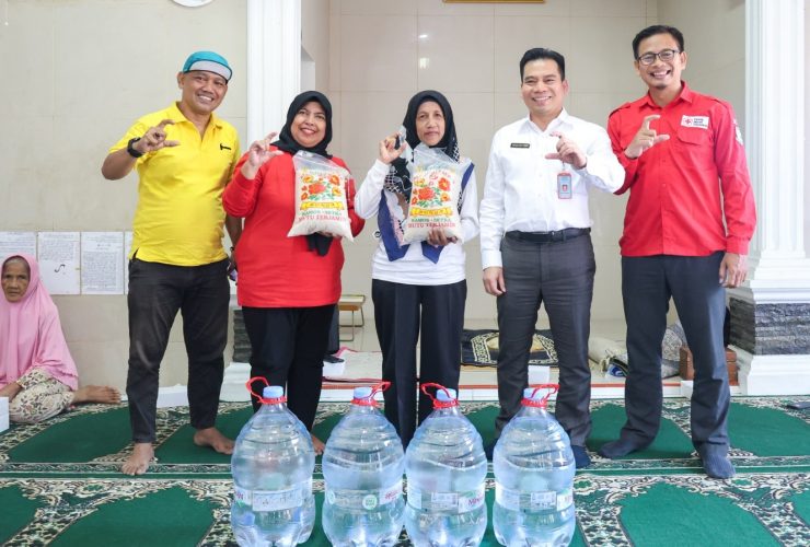 Sejumlah perwakilan Pemerintah Kota Tangerang Selatan dan PMI Kota Tangsel berfoto bersama warga terdampak TPA Cipeucang sambil menyerahkan bantuan air bersih dan beras untuk 50 kepala keluarga di lokasi terdampak.